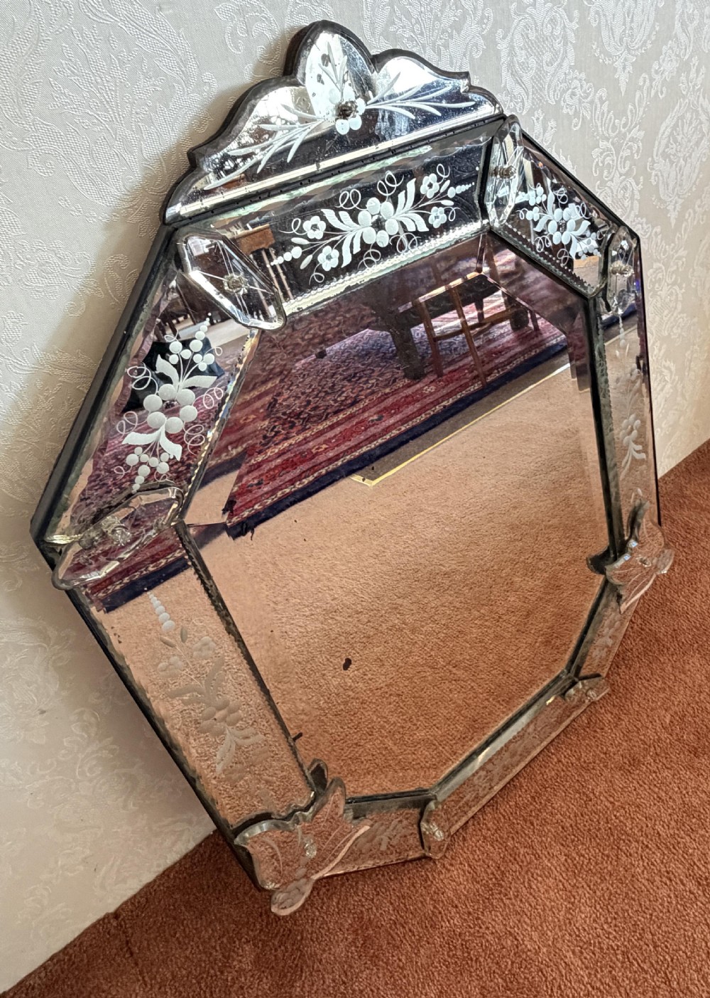 A late 19th-century shaped Venetian glass wall mirror featuring hand-etched floral glass borders, glass leaf corner appliques, and an ornate top crest. View IV