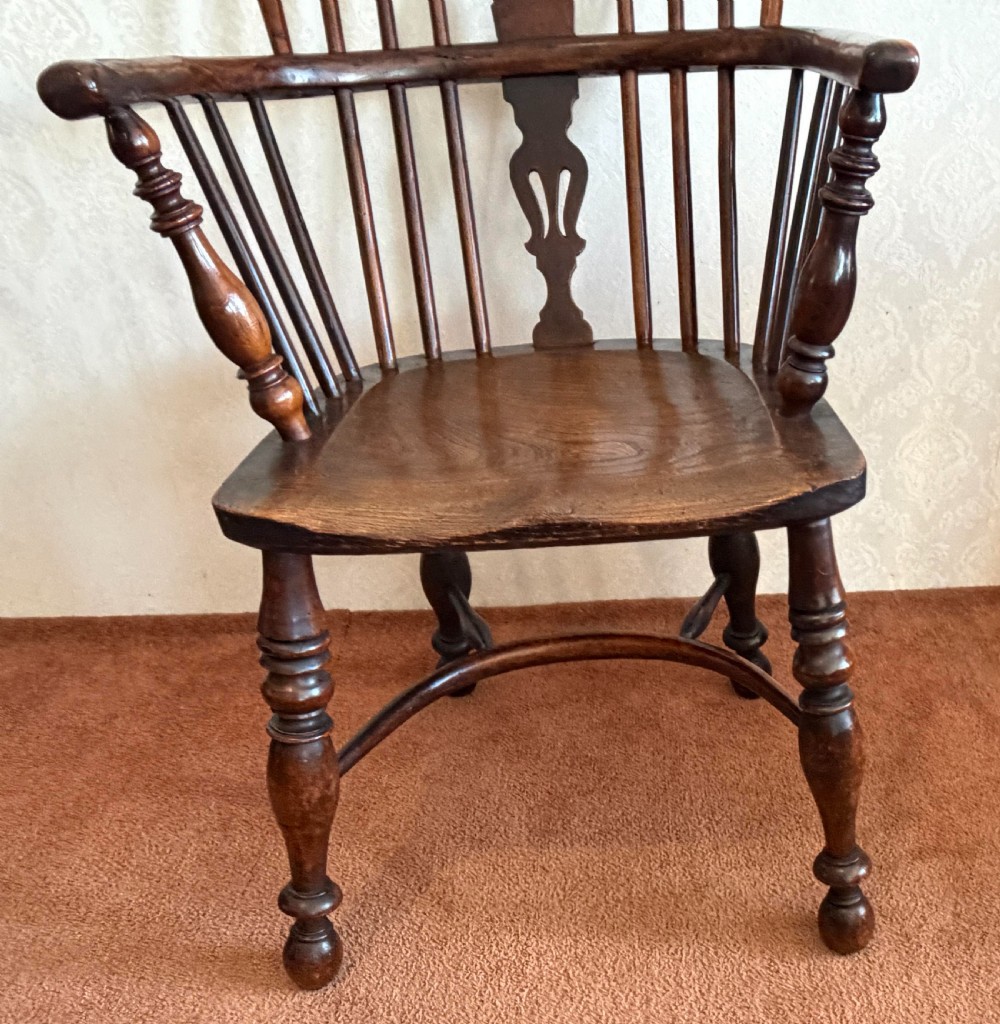 A dark wood high-back Windsor armchair featuring a pierced decorative splat, hoop back, turned leg stretchers, and shaped arm supports. View II