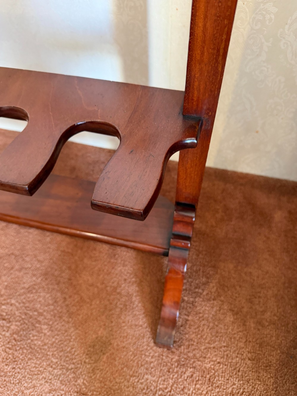 A mahogany wooden boot and whip stand featuring two notched horizontal tiers, top finials, and a lower shelf on curved feet. View II