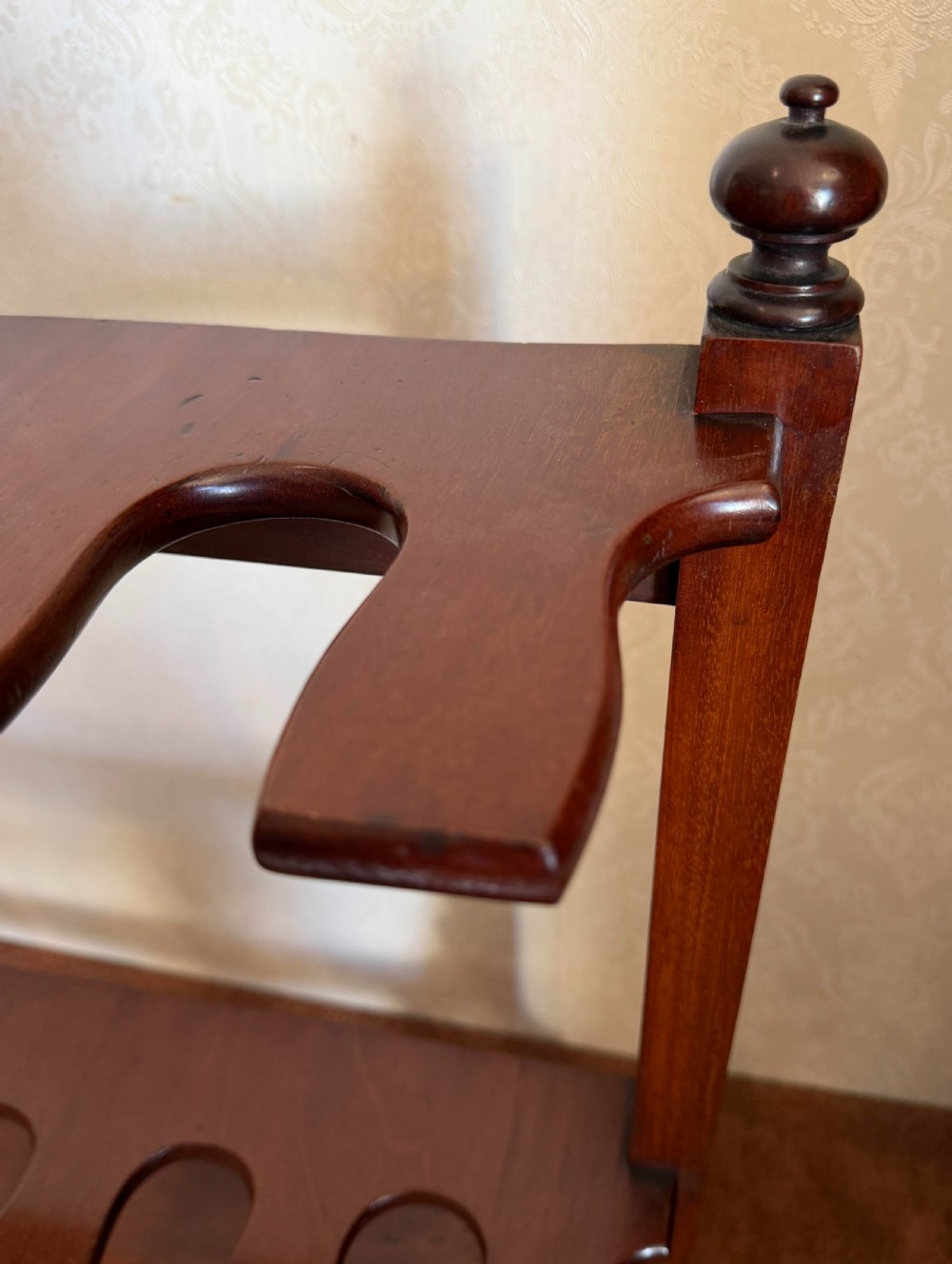 A mahogany wooden boot and whip stand featuring two notched horizontal tiers, top finials, and a lower shelf on curved feet. View III