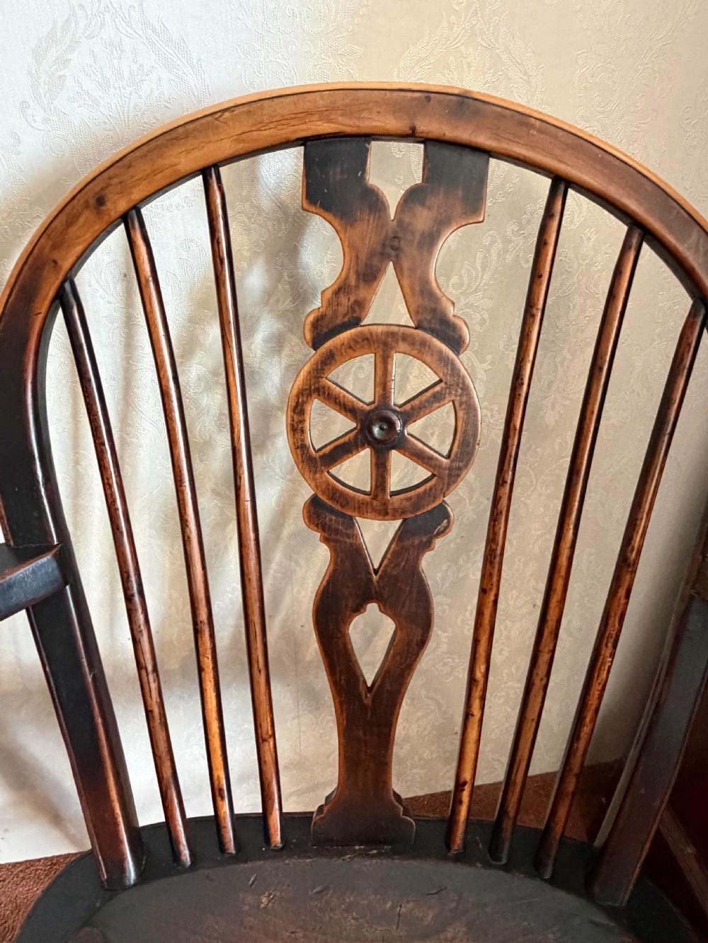A near pair of wooden wheelback Windsor armchairs with curved hoops, turned legs, and carved central back splats. View III