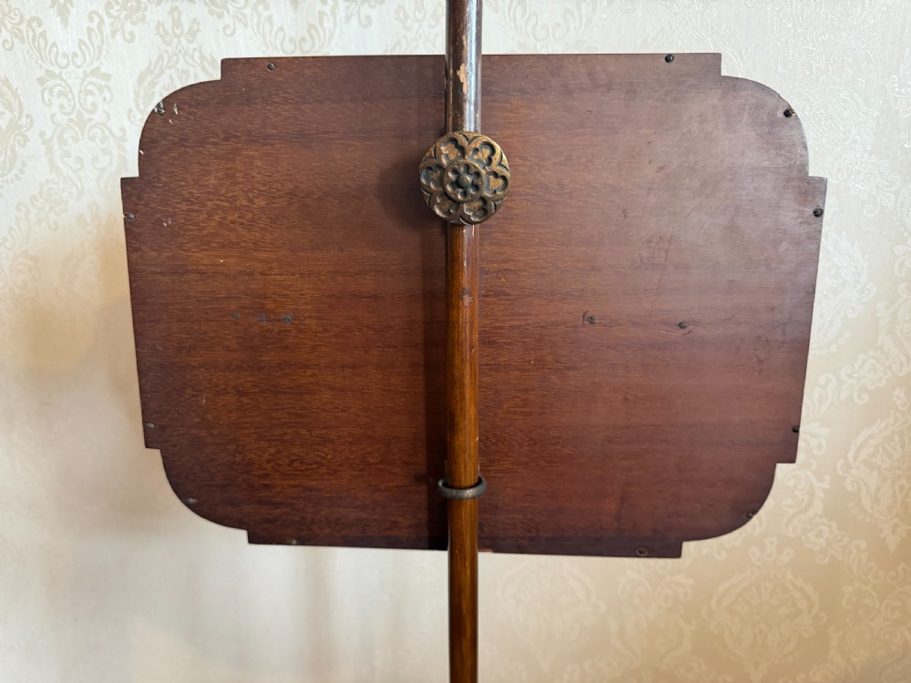 A mahogany pole screen featuring a slender turned shaft on a tripod cabriole base with an adjustable framed embroidered panel depicting a garden path. View IV