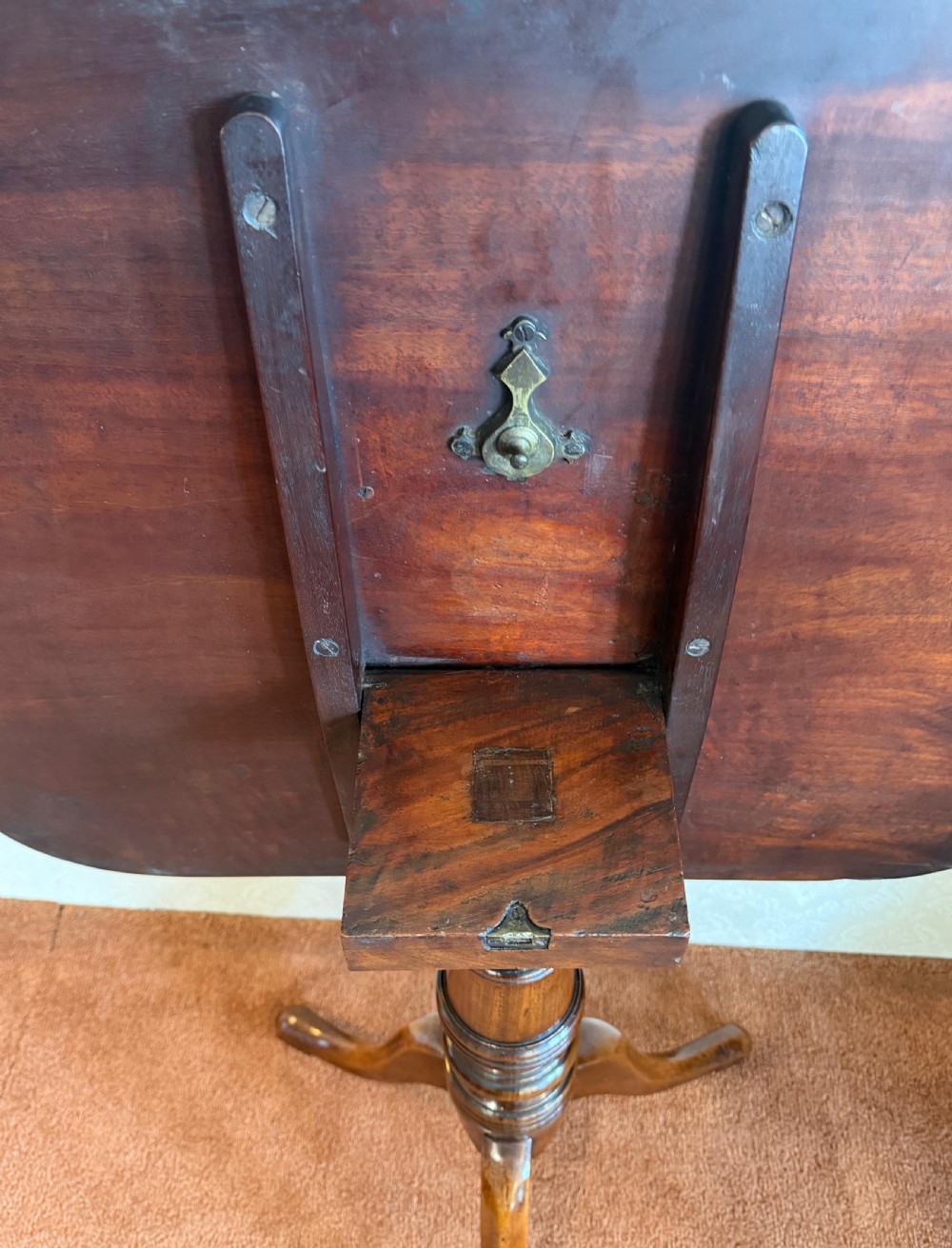 A Georgian mahogany tripod table featuring a rounded rectangular tilt-top surface, a ring-turned central pedestal, and three downswept legs. View IV