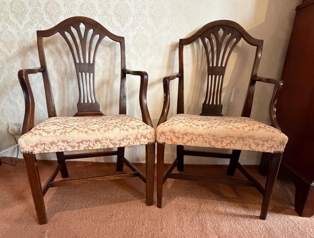 A pair of mahogany Hepplewhite style armchairs featuring carved pierced splats and patterned upholstered drop-in seats. View II