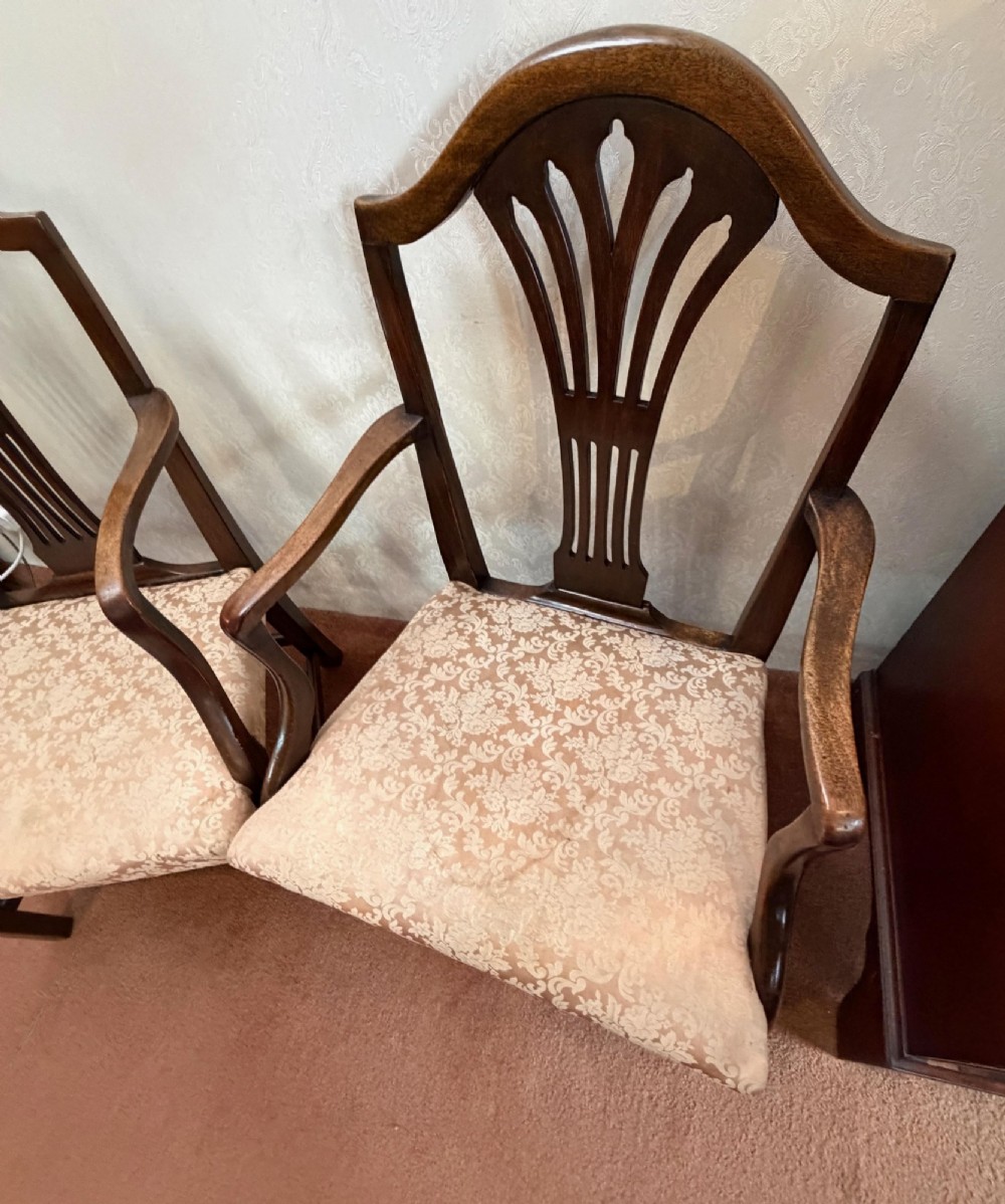 A pair of mahogany Hepplewhite style armchairs featuring carved pierced splats and patterned upholstered drop-in seats. View IV