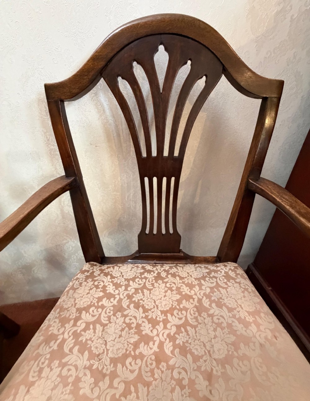 A pair of mahogany Hepplewhite style armchairs featuring carved pierced splats and patterned upholstered drop-in seats. View V