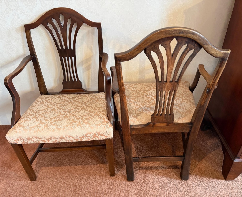 A pair of mahogany Hepplewhite style armchairs featuring carved pierced splats and patterned upholstered drop-in seats. View VIII