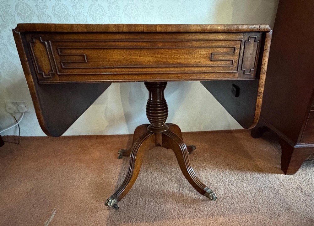 A Regency mahogany drop leaf breakfast table with a reeded central pedestal support and four splayed sabre legs with brass paw castors. View VIII