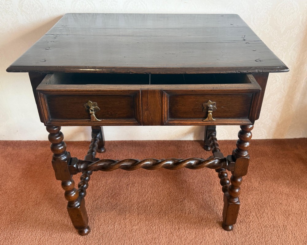 A dark oak side table featuring bobbin-turned legs, barley twist stretchers, and two drawers with brass handles. View III
