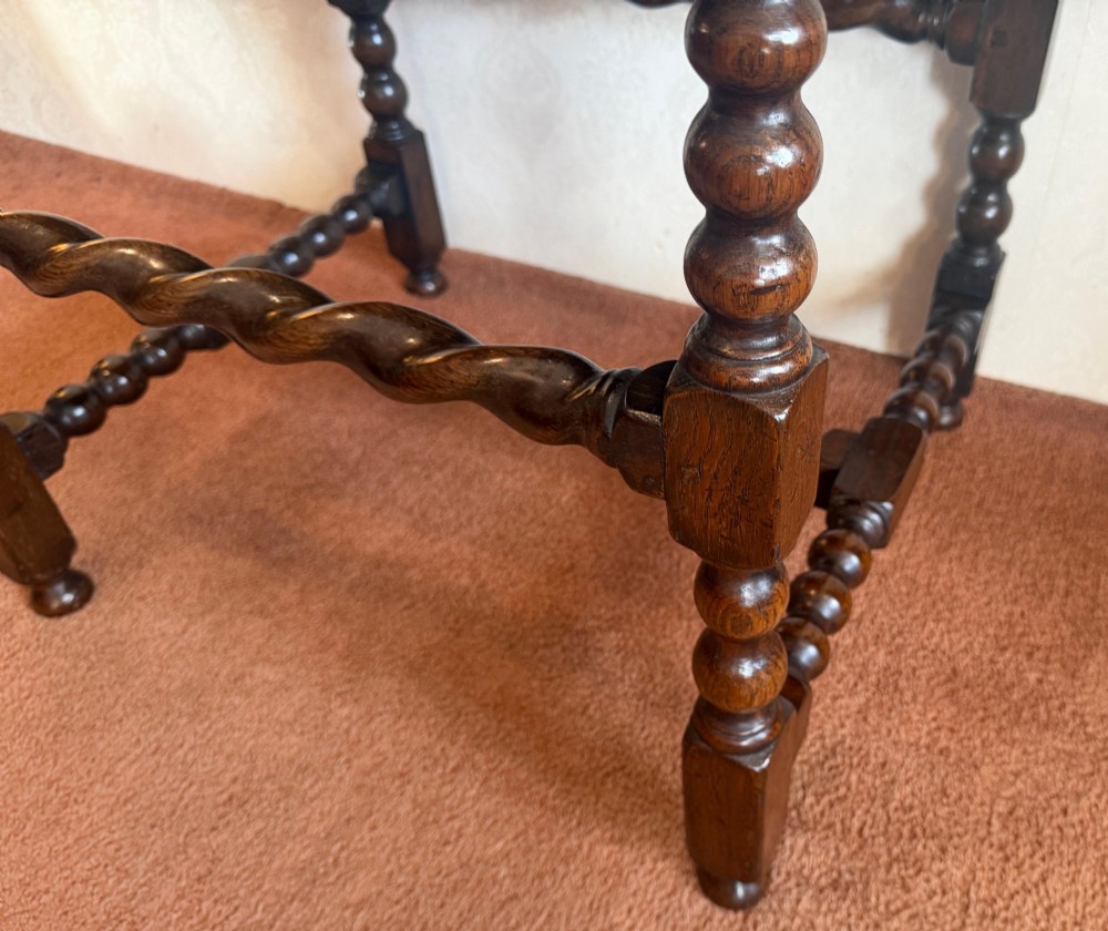 A dark oak side table featuring bobbin-turned legs, barley twist stretchers, and two drawers with brass handles. View IV