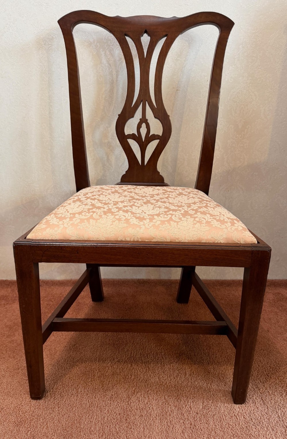 A mid-18th-century mahogany dining chair featuring a carved pierced back splat, serpentine crest rail, and a patterned damask drop-in seat. View II