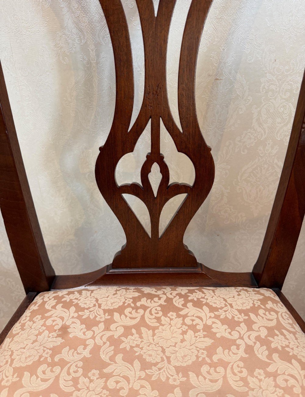 A mid-18th-century mahogany dining chair featuring a carved pierced back splat, serpentine crest rail, and a patterned damask drop-in seat. View III
