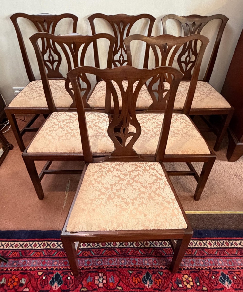 A mid-18th-century mahogany dining chair featuring a carved pierced back splat, serpentine crest rail, and a patterned damask drop-in seat. View IV