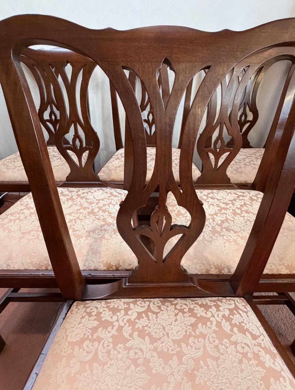 A mid-18th-century mahogany dining chair featuring a carved pierced back splat, serpentine crest rail, and a patterned damask drop-in seat. View VI