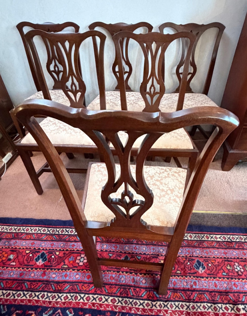 A mid-18th-century mahogany dining chair featuring a carved pierced back splat, serpentine crest rail, and a patterned damask drop-in seat. View VII