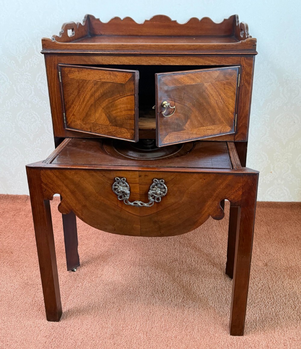 Mid-18th century Georgian mahogany bedside cabinet featuring a tray top gallery with cut-out handholds, double cupboard doors, lower drawer, and square legs. View III