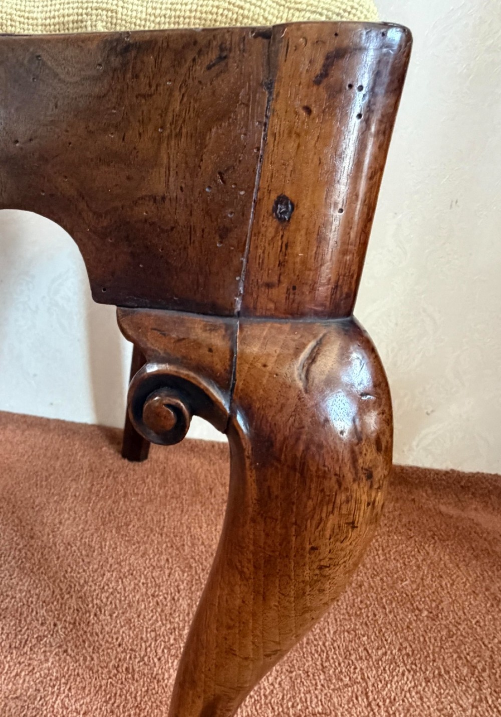 An early 18th-century walnut side chair featuring a carved pierced splat back, shaped apron, cabriole front legs, and an embroidered drop-in seat pad. View III