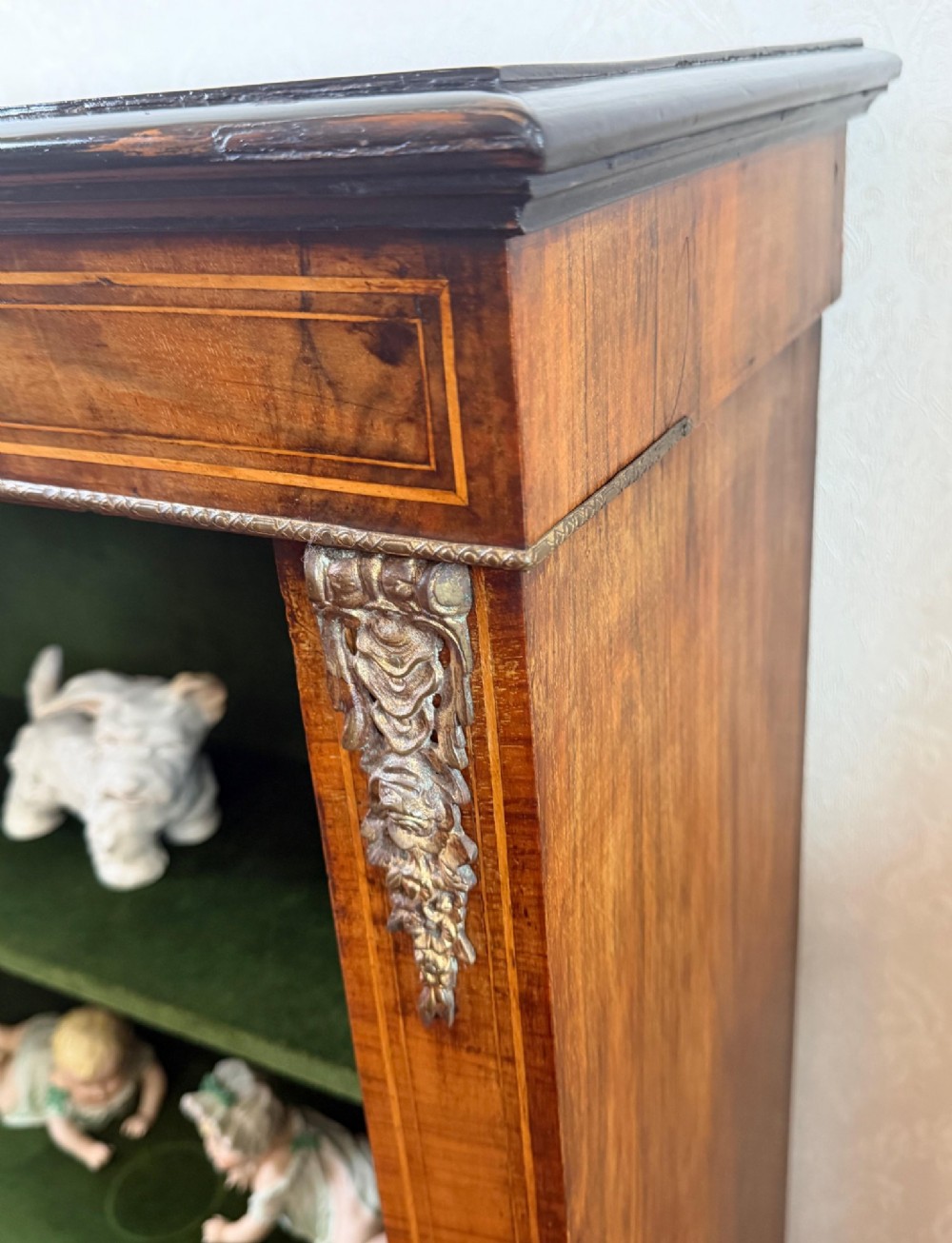 A Victorian burr walnut pier cabinet with floral marquetry inlay, ornate gilt brass mounts, and a single glazed door disclosing velvet-lined shelving. View III