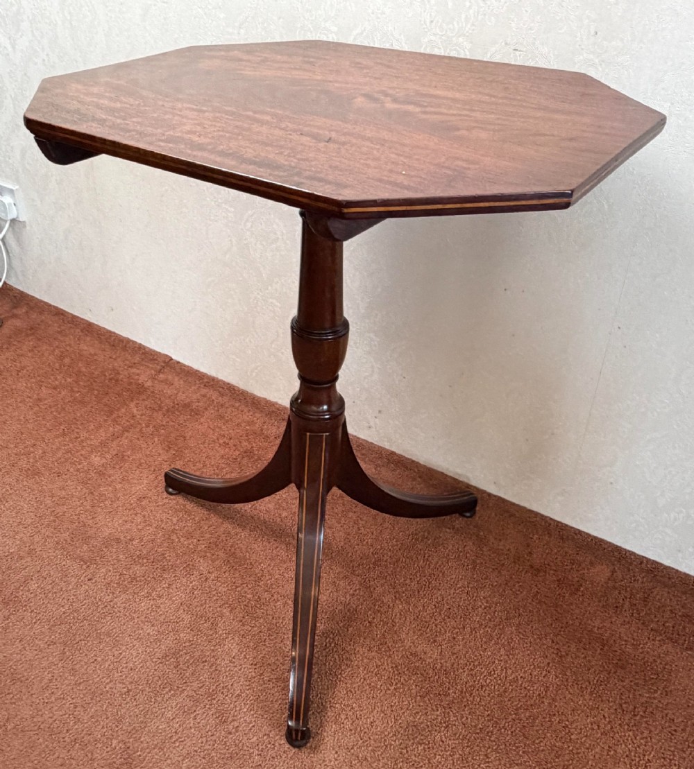 A mahogany tripod table featuring an octagonal top with boxwood line inlay along the edge and down the three splayed legs. View III