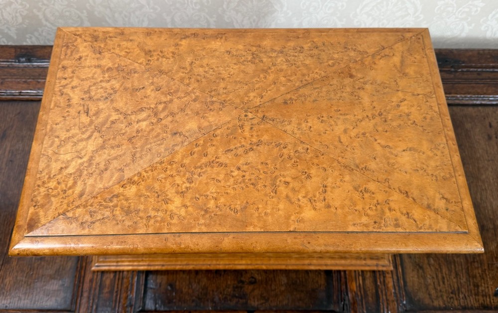 An early nineteenth-century William IV birdseye maple tea caddy featuring a faceted lid and brass keyhole escutcheon. View IV