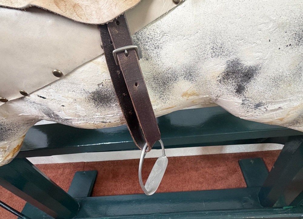 A 19th-century carved wooden dappled grey rocking horse with a leather saddle, horsehair mane, and dark green painted glider stand. View VII