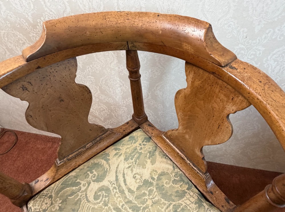 An 18th-century oak corner chair featuring turned supports, two vase-shaped back splats, a curved top rail, and a patterned green fabric drop-in seat. View III