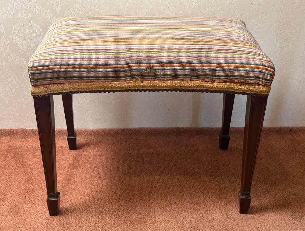A late 18th-century mahogany stool with square tapering legs and a seat upholstered in multi-coloured vertical striped fabric with braided trim. View III