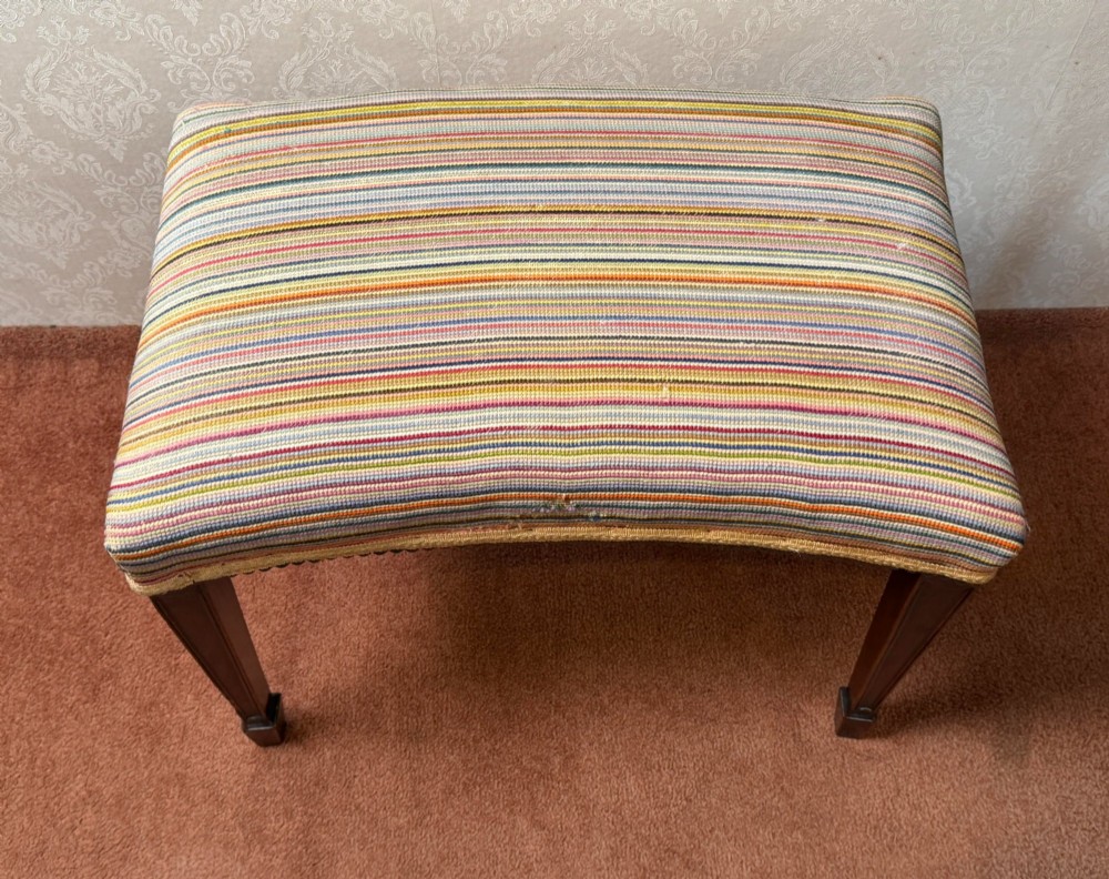 A late 18th-century mahogany stool with square tapering legs and a seat upholstered in multi-coloured vertical striped fabric with braided trim. View IV