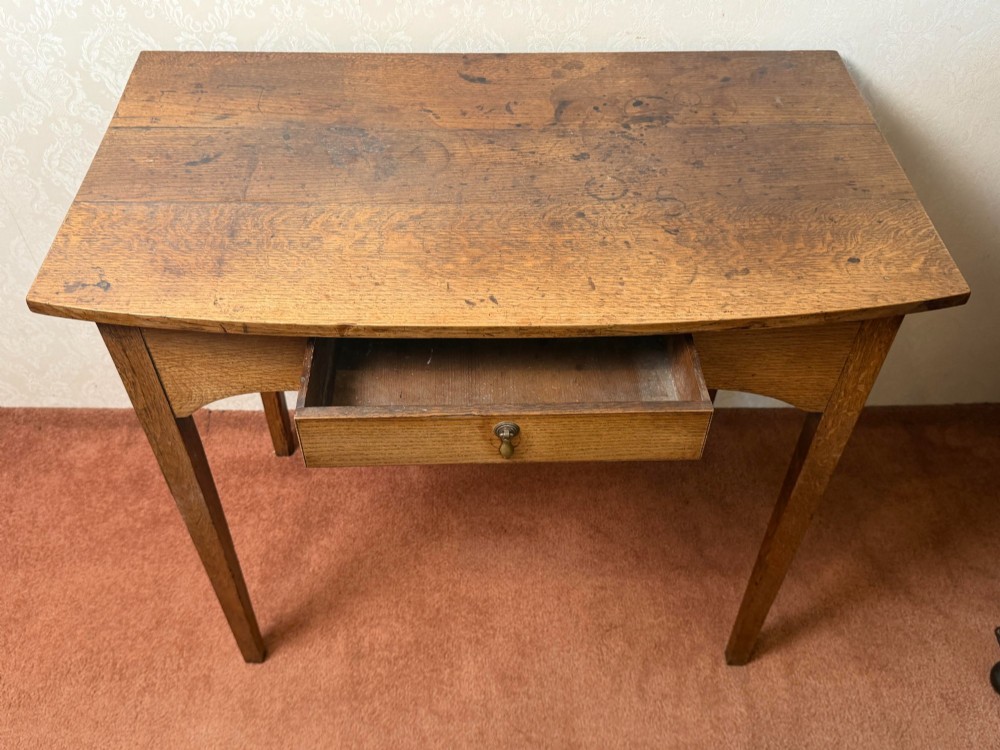An antique oak side table featuring a single fitted drawer with a brass drop handle, a contoured apron, and four square legs. View III