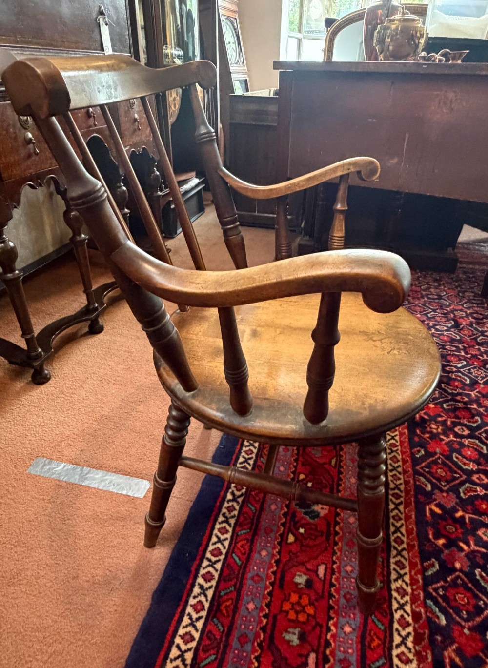 A Victorian ash wooden desk chair featuring turned legs, a contoured seat, curved armrests, and a spindle backrest. View II