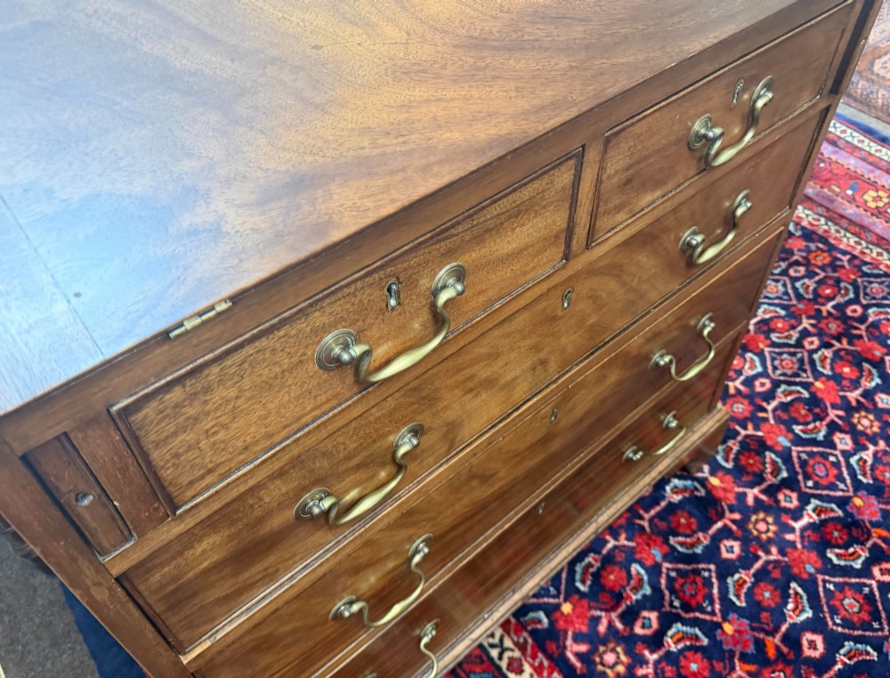 An antique burr walnut chest of drawers featuring two short over three long drawers with ornate brass drop handles and bracket feet. View II