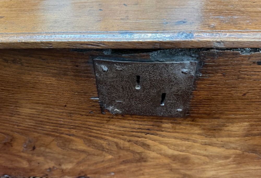 A dark oak antique plank sword chest featuring a central iron lockplate and bootjack end supports. View II