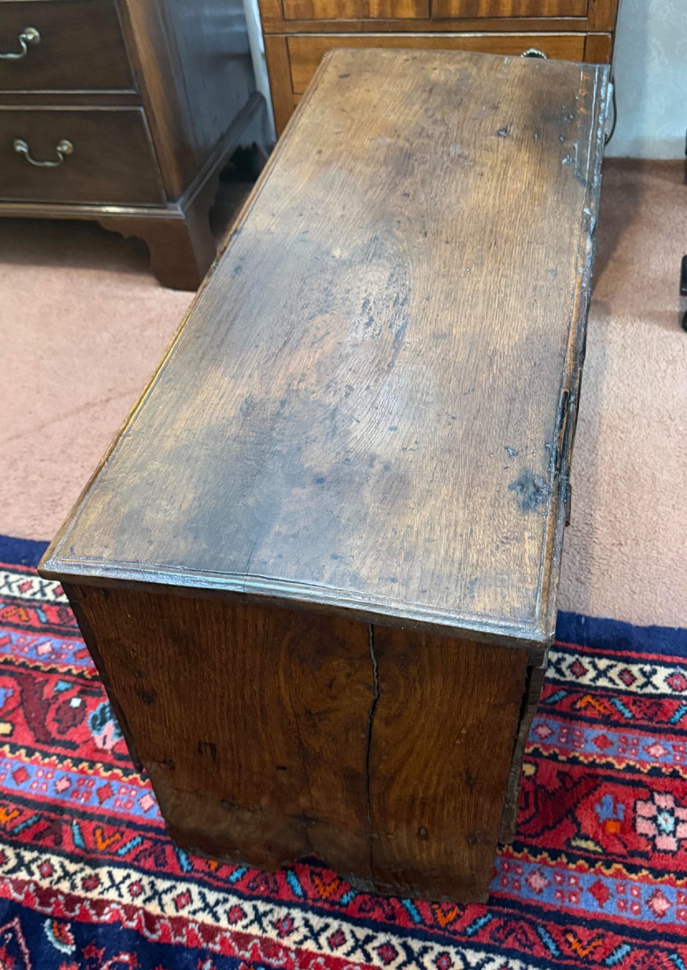 A dark oak antique plank sword chest featuring a central iron lockplate and bootjack end supports. View IV