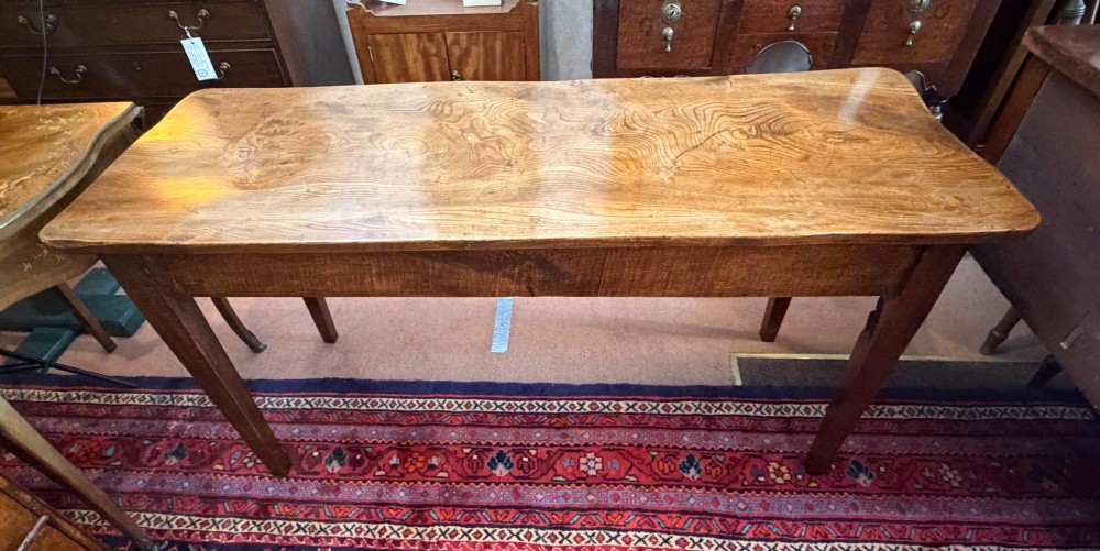 A rectangular antique wooden farmhouse table featuring a highly figured timber grain top supported by four square tapered legs. View III