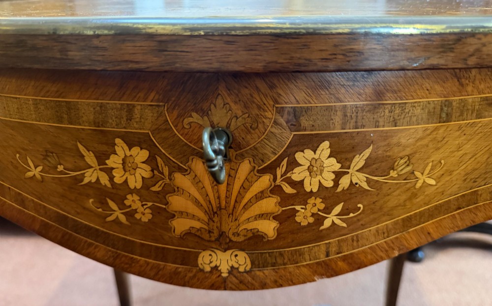 A Louis XV style walnut and kingswood side table featuring floral marquetry inlay, cabriole legs, and gilded brass mounts. View II