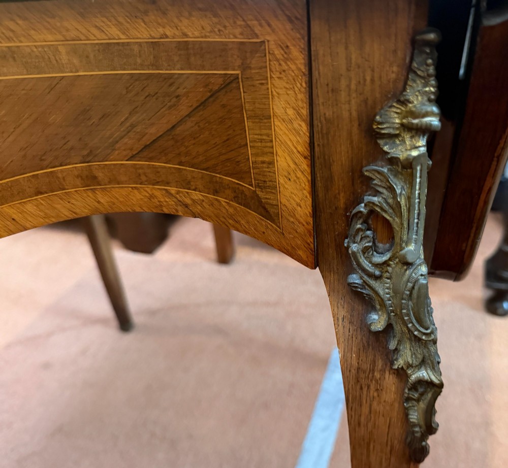 A Louis XV style walnut and kingswood side table featuring floral marquetry inlay, cabriole legs, and gilded brass mounts. View III