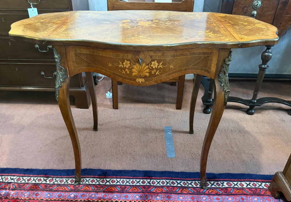 A Louis XV style walnut and kingswood side table featuring floral marquetry inlay, cabriole legs, and gilded brass mounts. View IV