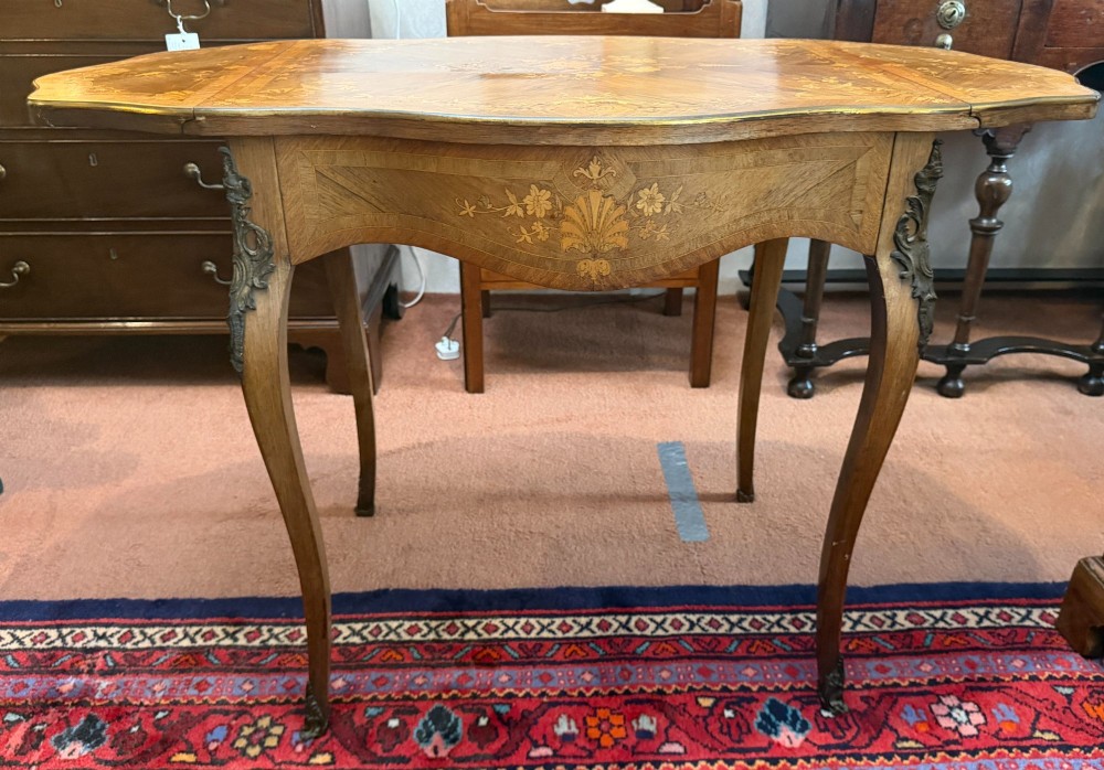 A Louis XV style walnut and kingswood side table featuring floral marquetry inlay, cabriole legs, and gilded brass mounts. View VII