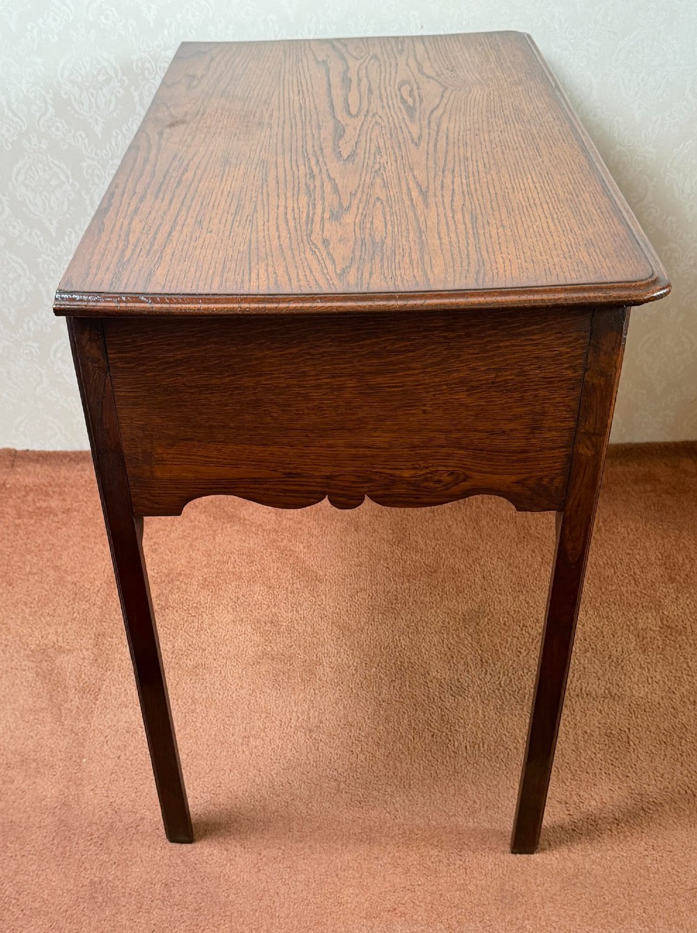 An 18th-century Georgian oak side table featuring five drawers, a central shaped apron, brass handles, and four straight legs. View V