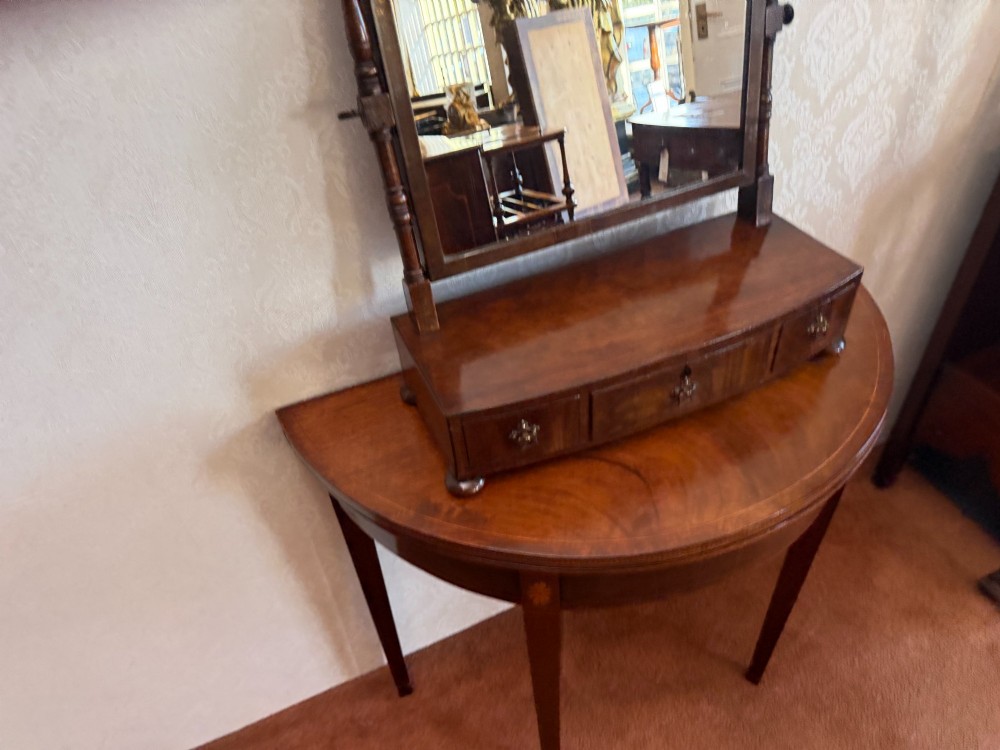 An early nineteenth-century mahogany box dressing mirror with a rectangular adjustable frame set above three drawers on small ball feet. View III