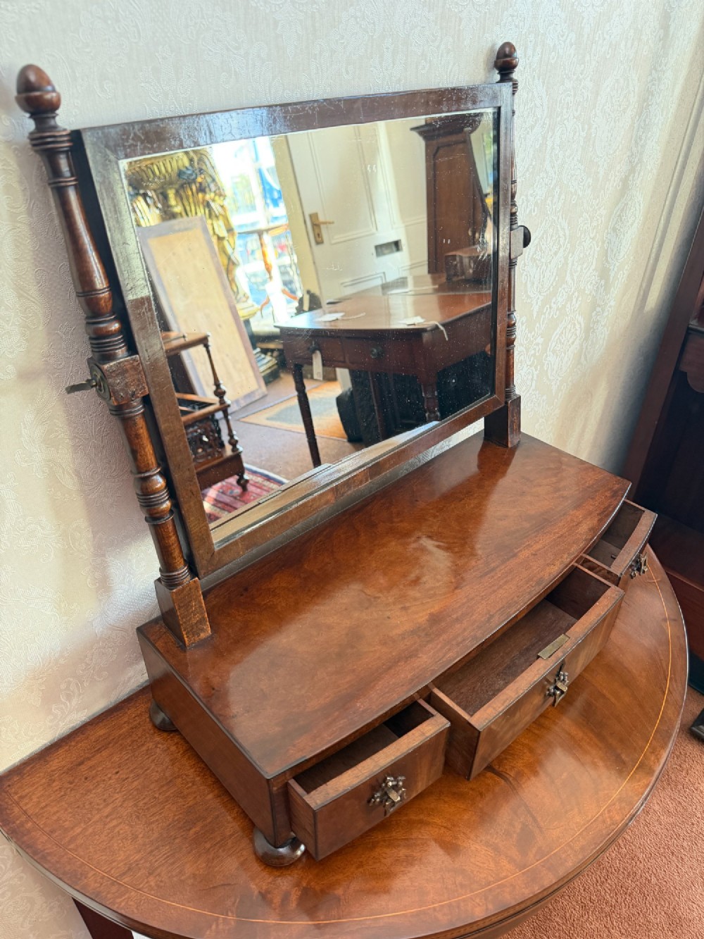 An early nineteenth-century mahogany box dressing mirror with a rectangular adjustable frame set above three drawers on small ball feet. View VI