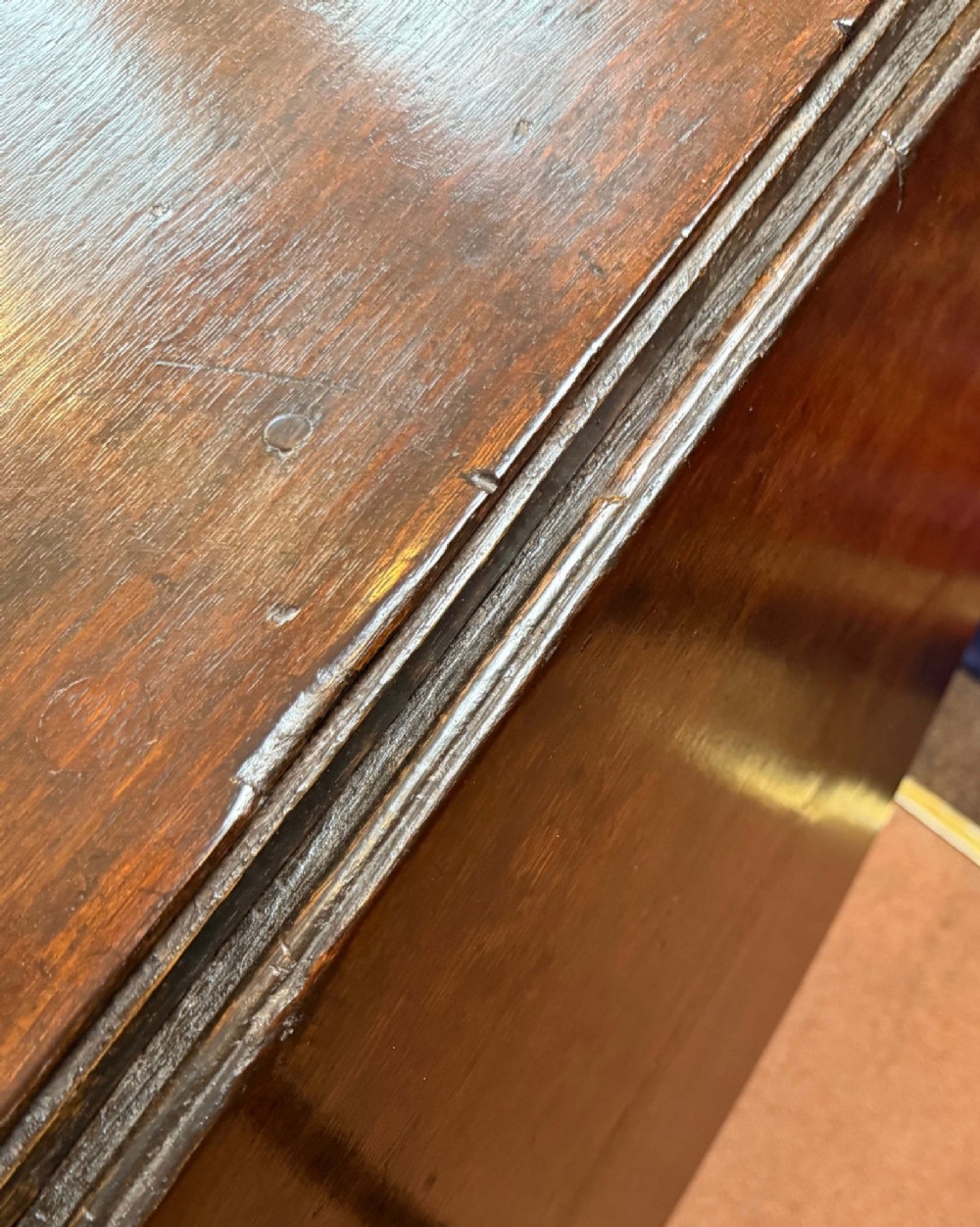 A 17th-century dark oak gateleg table shown with drop leaves lowered, featuring turned legs, a stretcher base, and a drawer with a brass teardrop pull handle. View VI