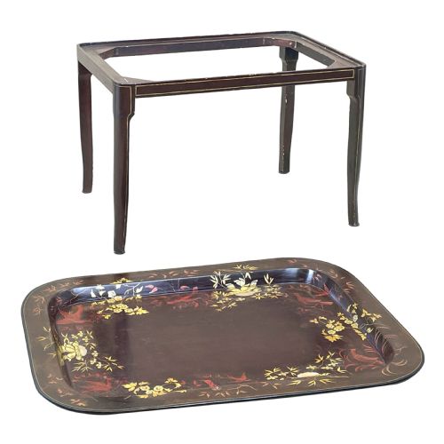 fig 2. A nineteenth-century dark lacquered papier-mache tray with gold floral decoration resting on a fitted dark wood stand with slender tapered legs.