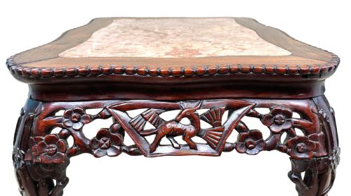 fig 2. A 19th-century rectangular dark hardwood low table with an inset marble panel top, deeply carved floral apron, and cabriole legs.