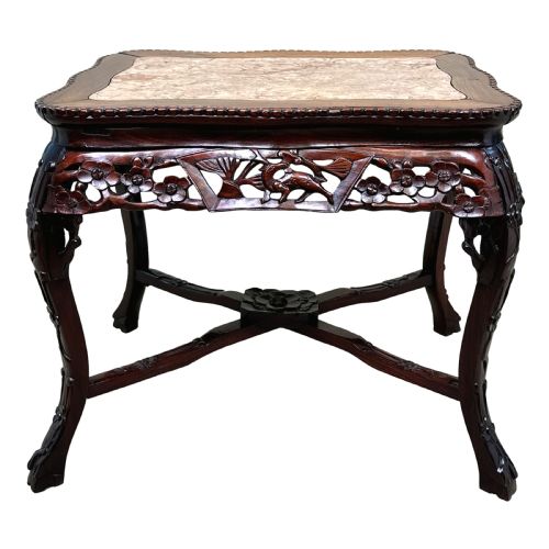 fig 4. A 19th-century rectangular dark hardwood low table with an inset marble panel top, deeply carved floral apron, and cabriole legs.