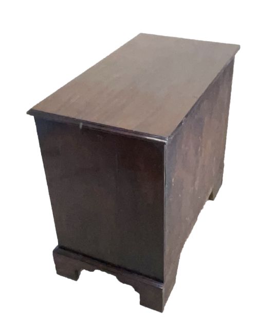 fig 2. An eighteenth-century Georgian mahogany chest of drawers featuring four graduated drawers, brass swan-neck handles, and bracket feet.