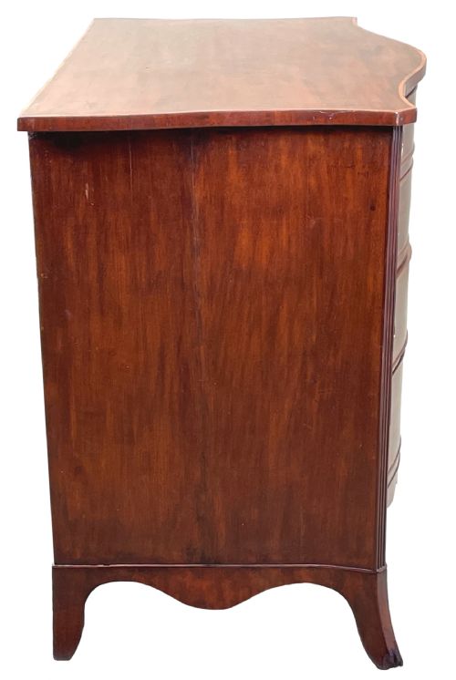 fig 2. A Georgian style mahogany chest of drawers featuring a serpentine front, four graduated drawers with brass ring handles, and bracket feet.