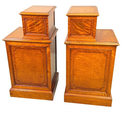 fig 1. A pair of 19th-century golden satinwood bedside chests featuring stepped top sections with drawers, crossbanded inlay, and brass ring handles.