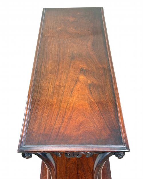 fig 1. A mid-19th century three-tier rosewood standing buffet unit featuring curved leg supports and carved scroll details.