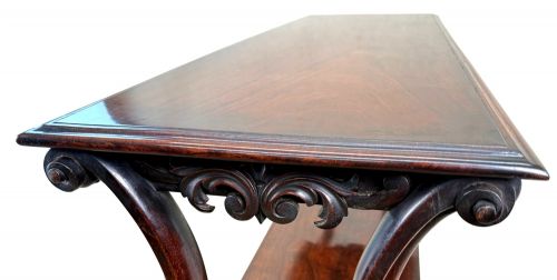 fig 3. A mid-19th century three-tier rosewood standing buffet unit featuring curved leg supports and carved scroll details.